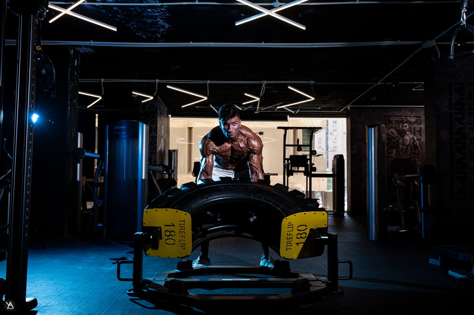 A wide, dark gym floor under dim lights before the session starts
