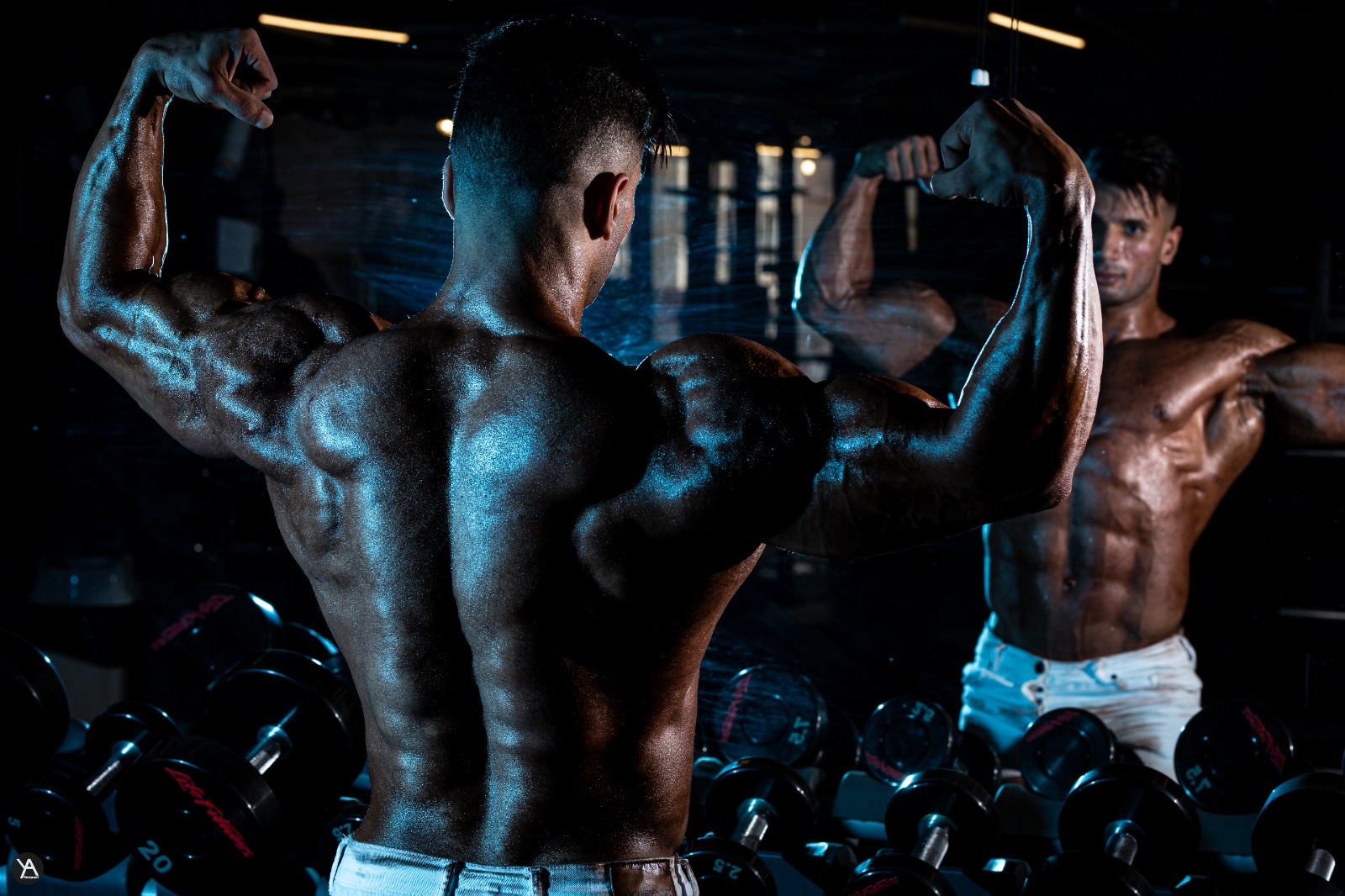 Adel performing a controlled dumbbell biceps curl